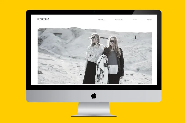 MINIMØ lifestyle magazine homepage with a black-and-white fashion photo, on a desktop monitor
